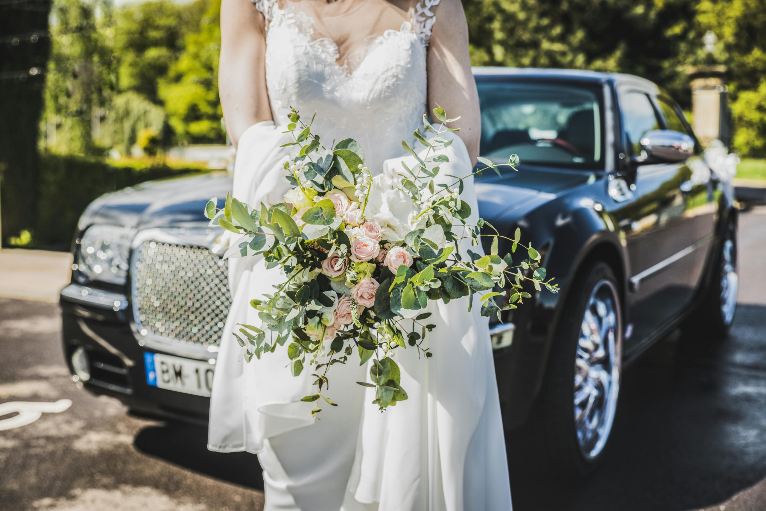 bride in white dress holding flowers